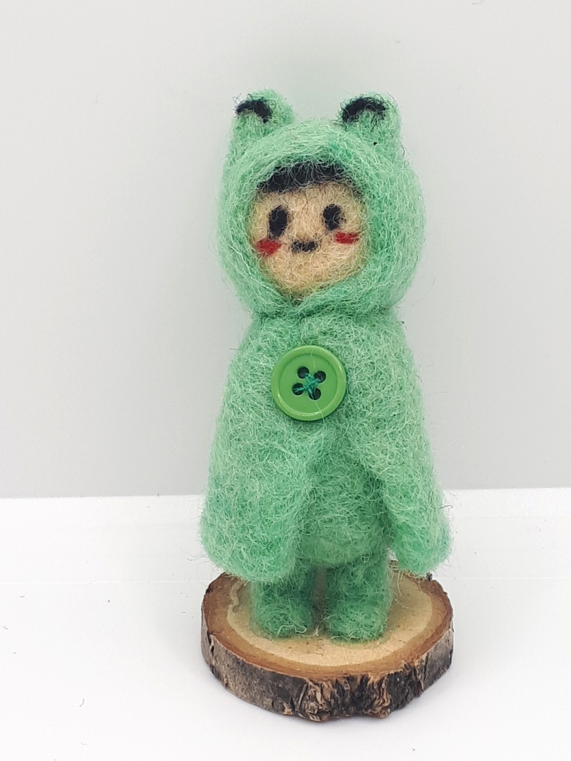 a child in a frog raincoat